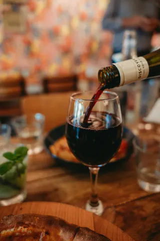 Red wine being poured into a glass