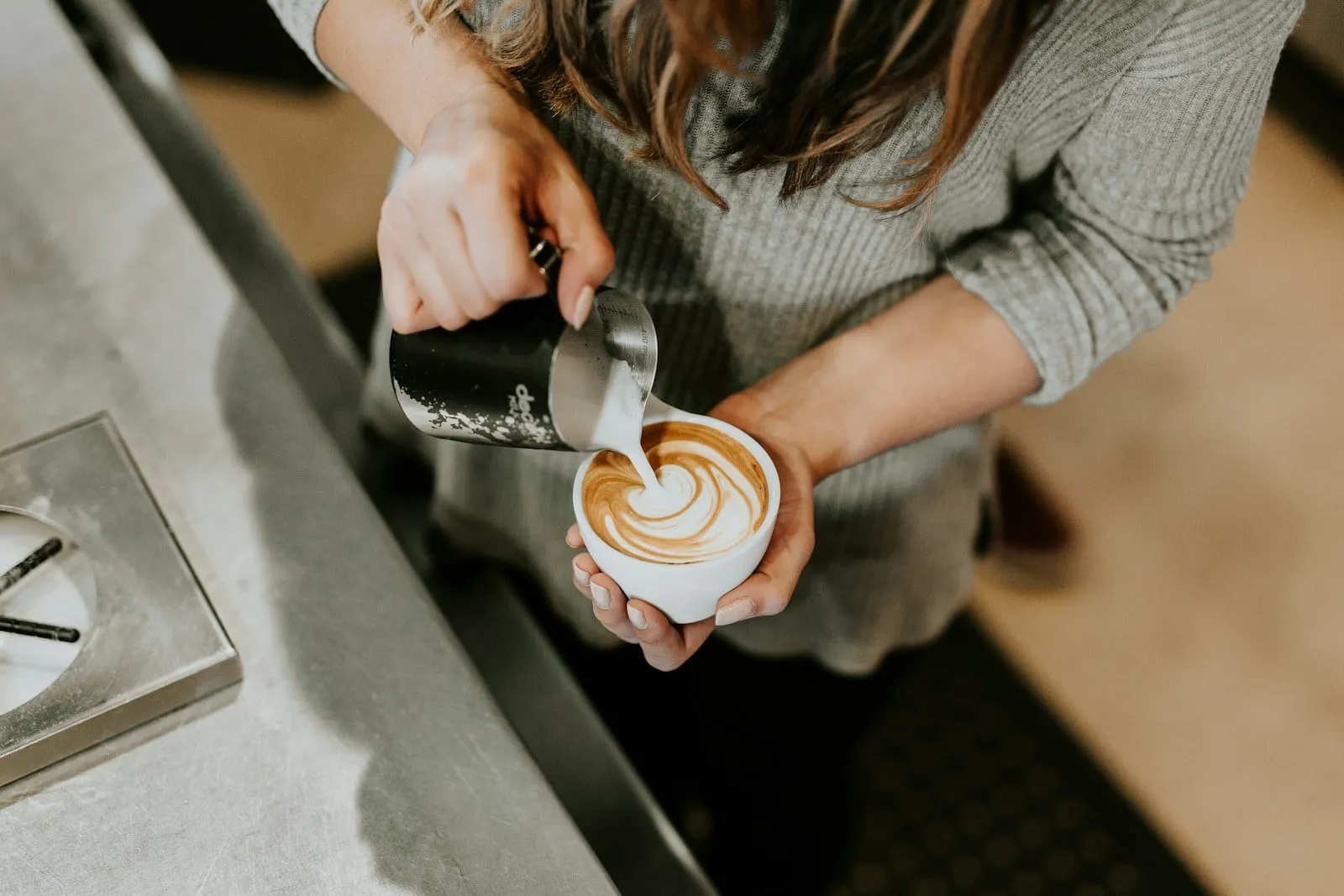A barista pouring latte art