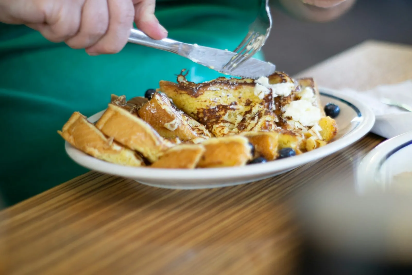 French toast with powdered sugar on a white plate
