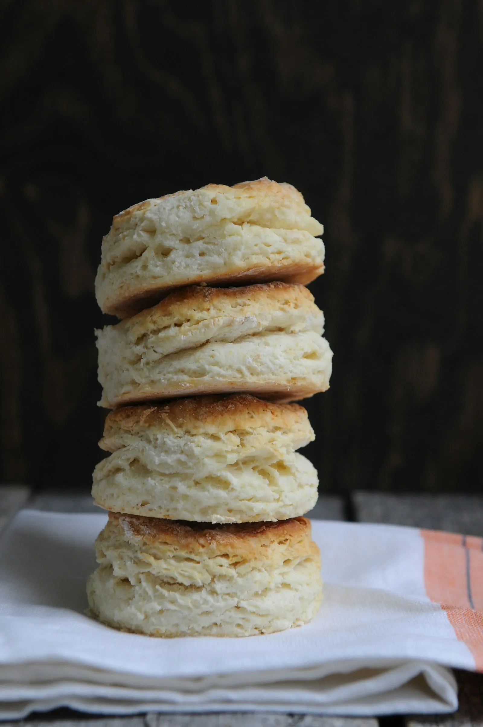 A tall stack of flaky buttermilk biscuits