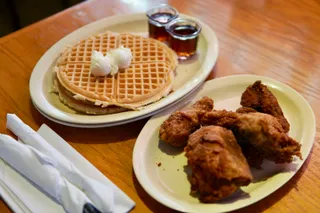 Fried chicken and a waffle with syrup