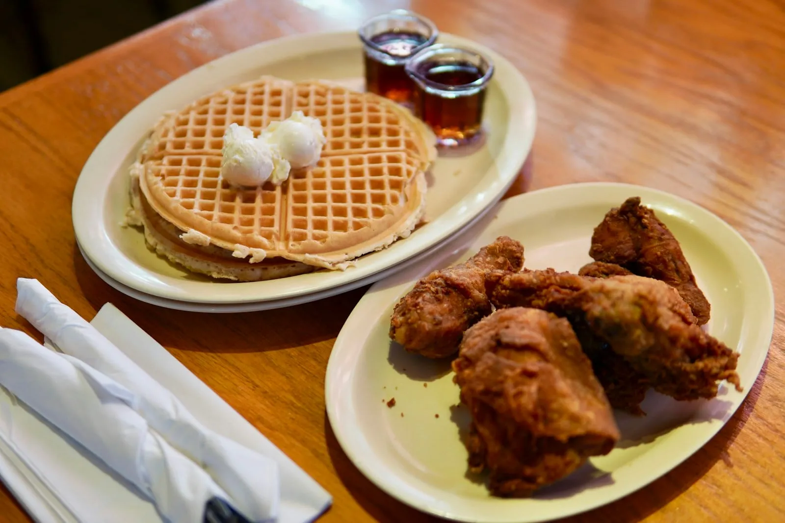 Fried chicken and a waffle with syrup