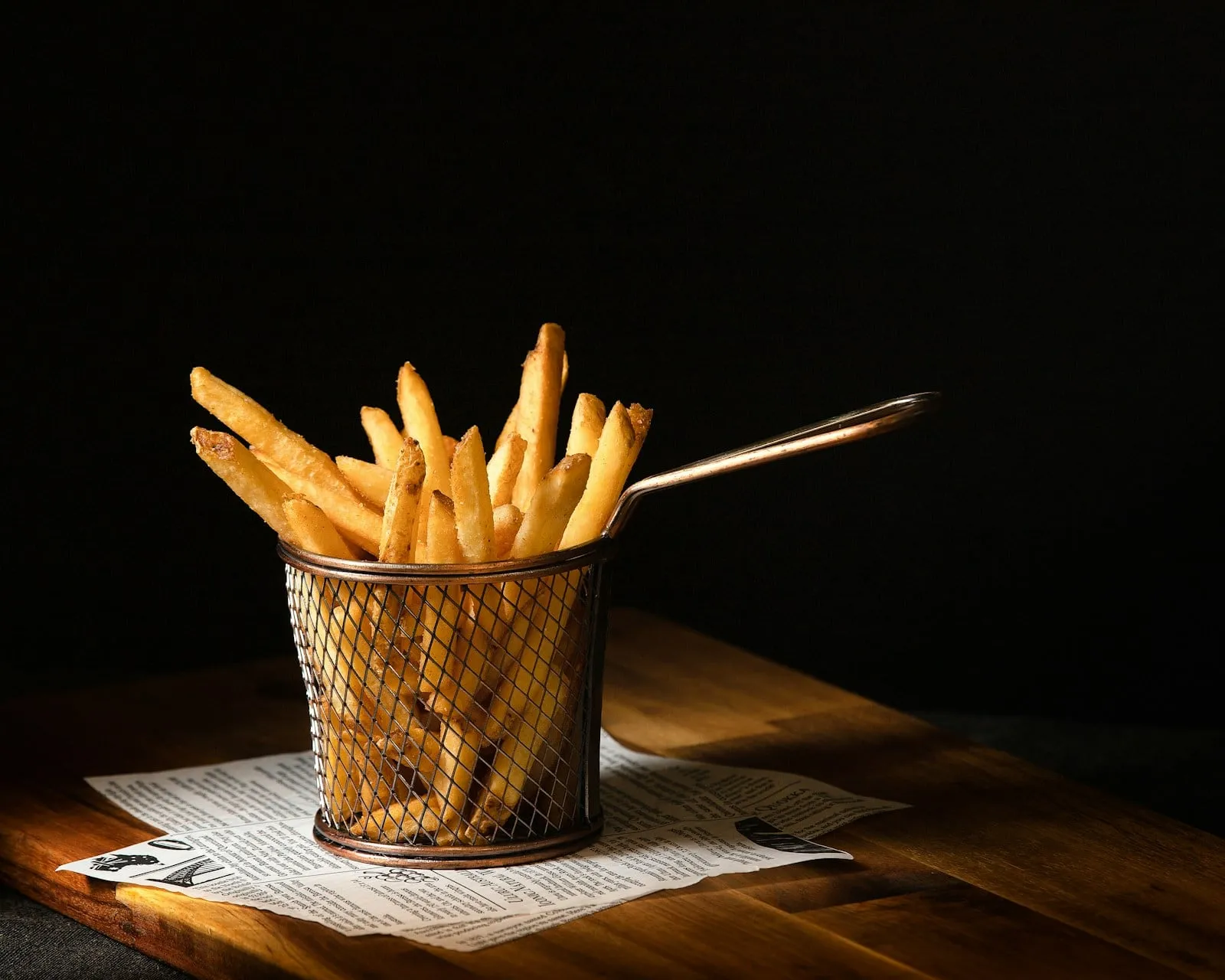 Golden french fries in a wire basket