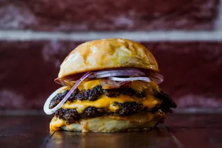 A double cheeseburger with grilled onions