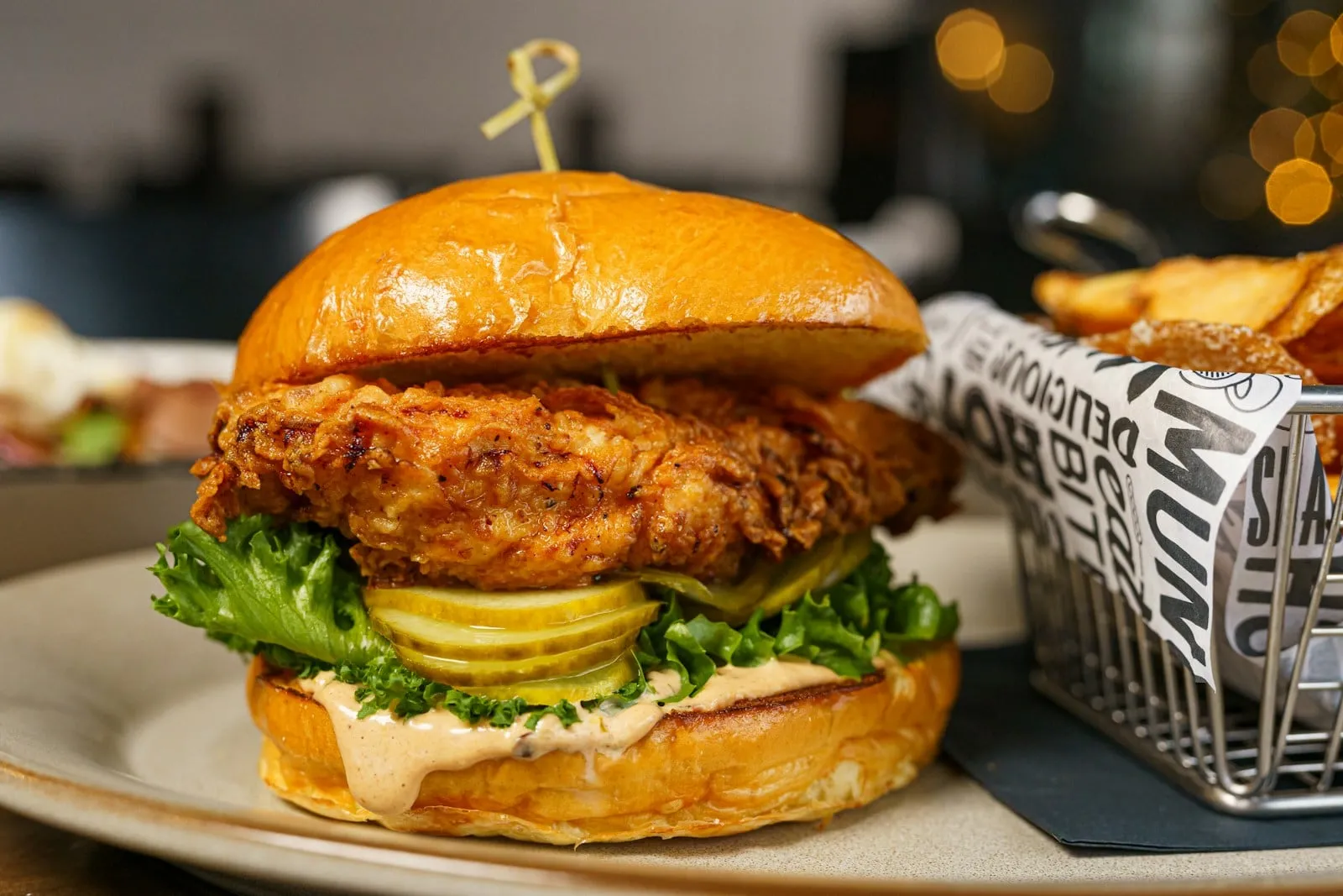 A crispy fried chicken sandwich with lettuce and pickles