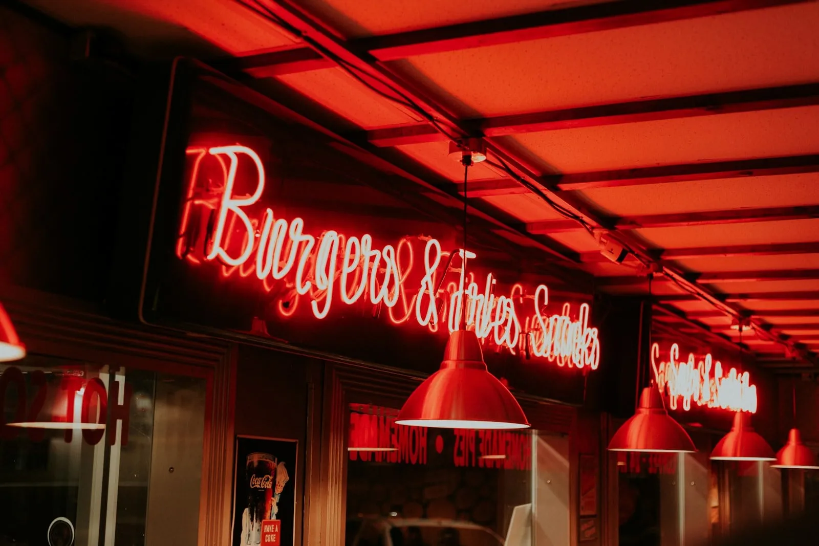 Red neon signs glowing over the counter