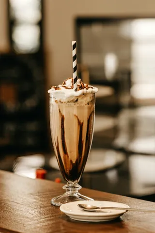 A chocolate milkshake with whipped cream