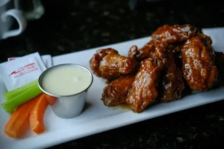 Glazed chicken wings with celery and ranch