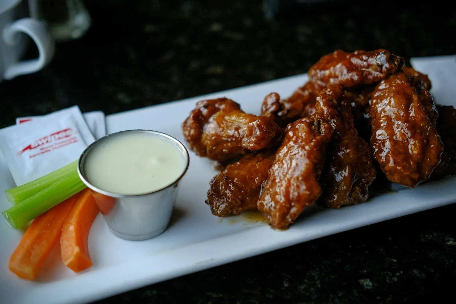 Glazed chicken wings with celery and ranch